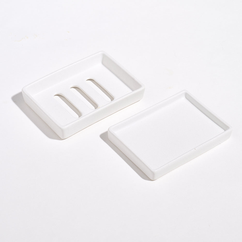 White marble jesmonite soap dish and a tray on a light gray background.