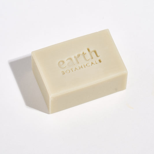 Bar of soap with 'earth botanicals' branding on a light background