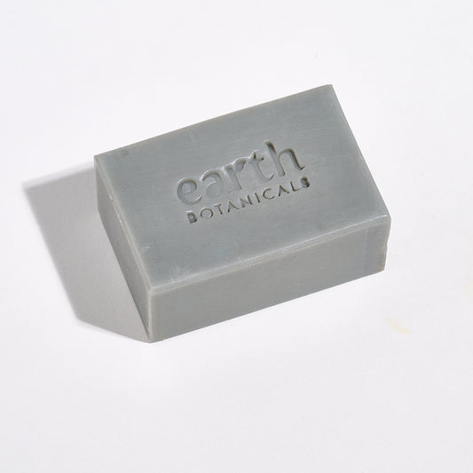 Bar of soap with 'earth botanicals' branding on a light background