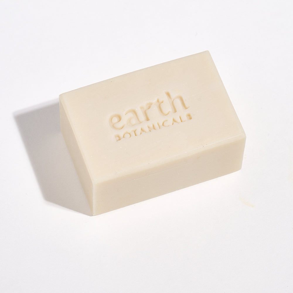 Bar of soap with 'earth botanicals' branding on a white background