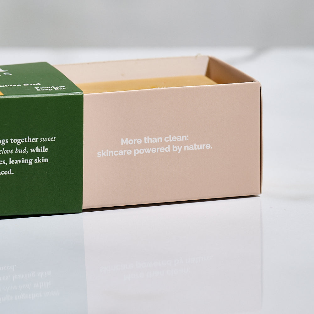 Two skincare product boxes with text on a light gray background