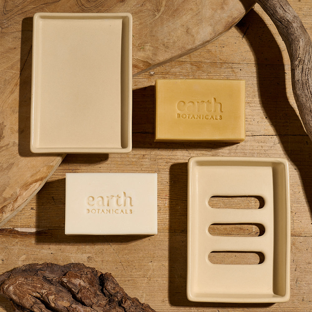Soap dish with drainage holes shown with tray and two soaps from the Ether Collection