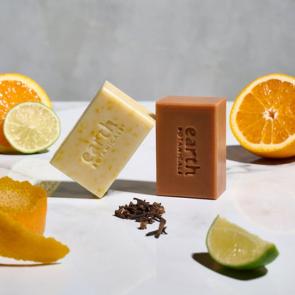 Aurora  sweet orange cypress and clove bud natural soap bar with fresh clove buds lime and orange and shown with Marigold from Earth Botanicals