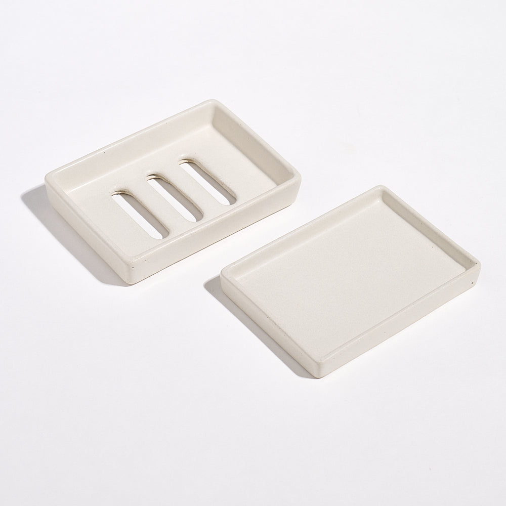 Portland Stone Jesmonite soap dishes and tray on a white background.
