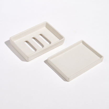 Portland Stone Jesmonite soap dishes and tray on a white background.