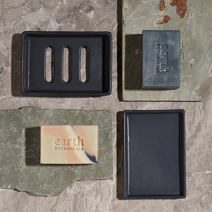 Hinterland and Woodnote natural soap bars with Charcoal Black Jesmonite soap dish on grey stone — Earth Collection Earth Botanicals